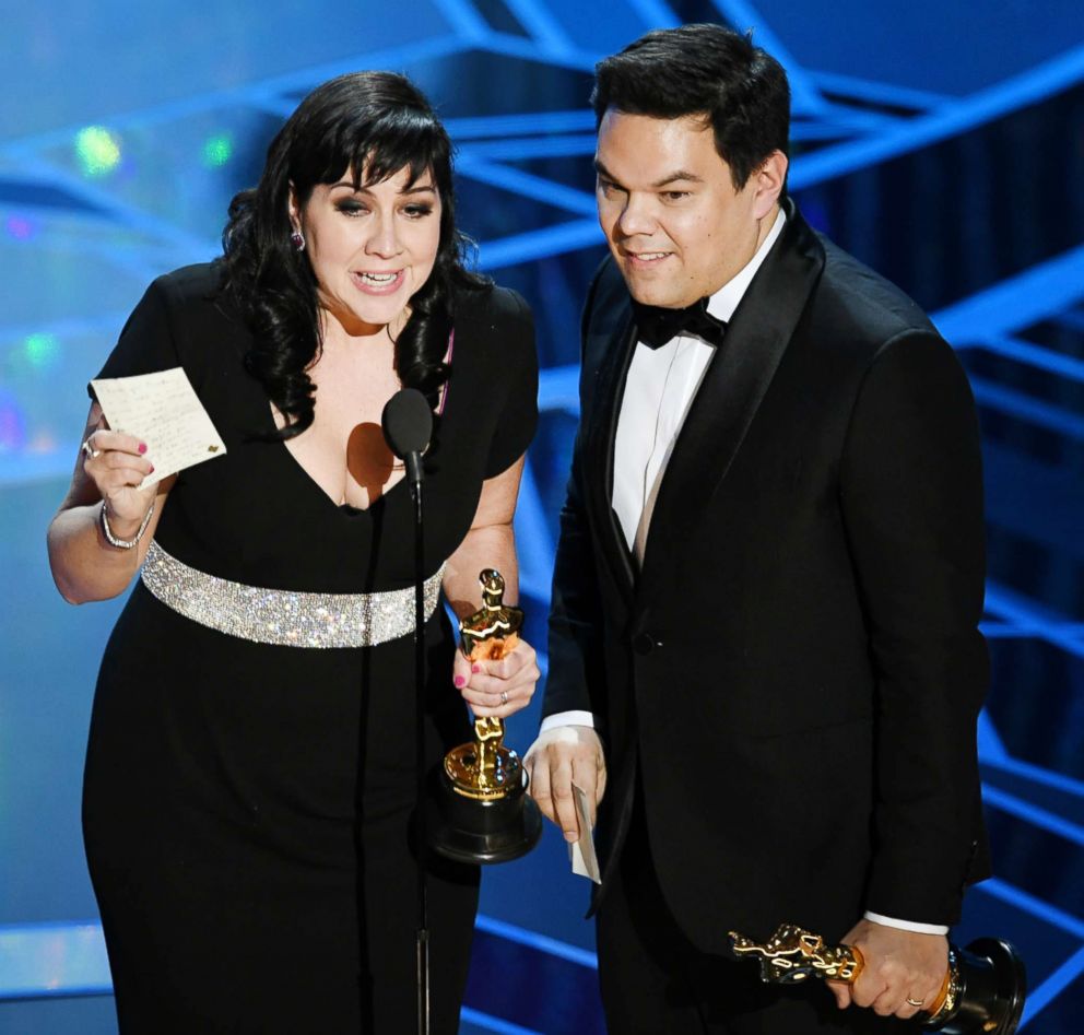 PHOTO: Kristen Anderson-Lopez and Robert Lopez accept best original song award for "Remember Me" from "Coco" during the Academy Awards on March 4, 2018, in Hollywood, Calif.