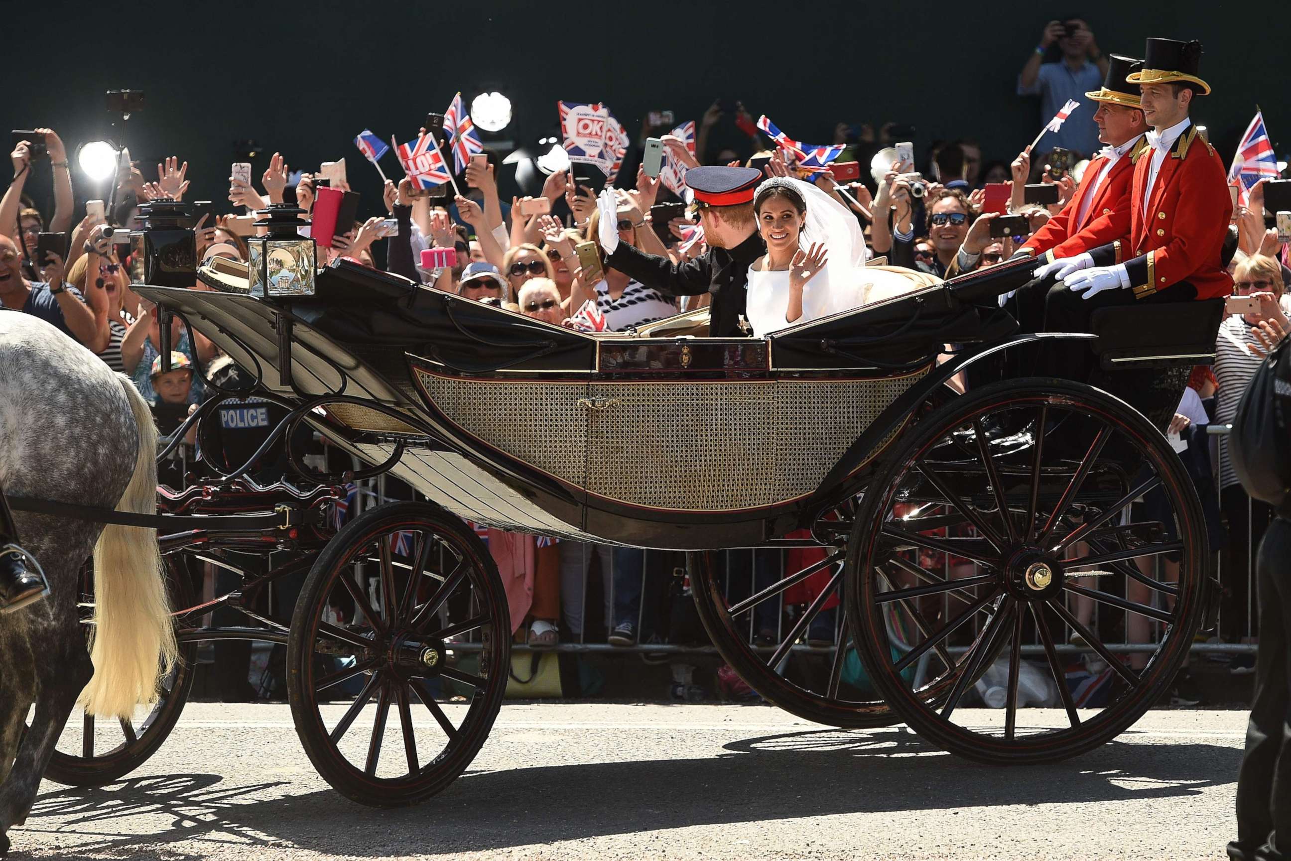 PHOTO: Prince Harry, Duke of Sussex and his wife Meghan, Duchess of Sussex wave from the carriage during their carriage procession on the Long Walk as they head back towards Windsor Castle in Windsor, England, May 19, 2018, after their wedding ceremony. 
