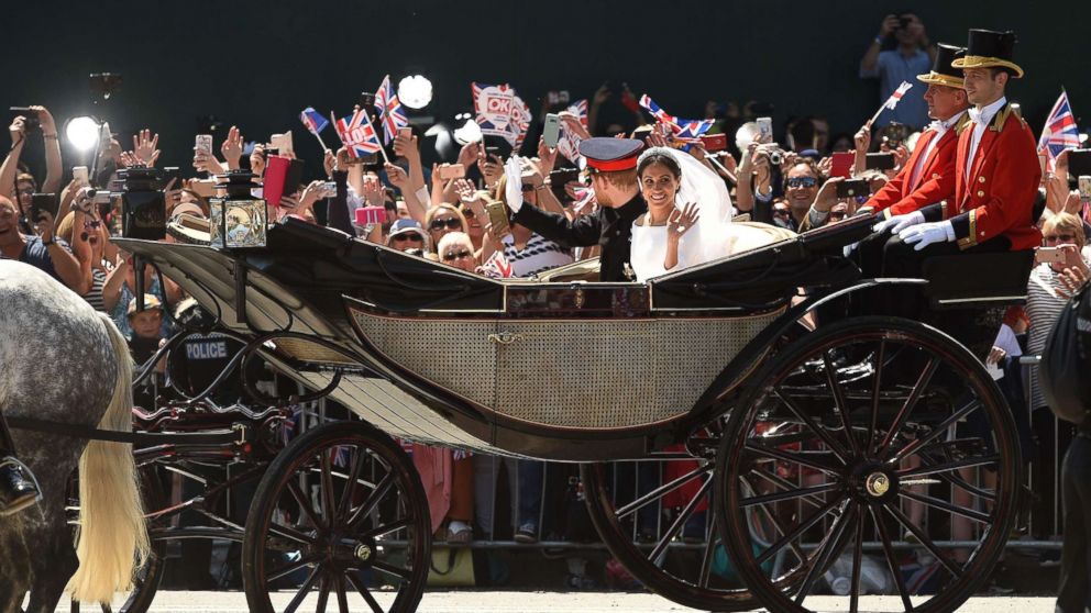 PHOTO: Prince Harry, Duke of Sussex and his wife Meghan, Duchess of Sussex wave from the carriage during their carriage procession on the Long Walk as they head back towards Windsor Castle in Windsor, England, May 19, 2018, after their wedding ceremony. 