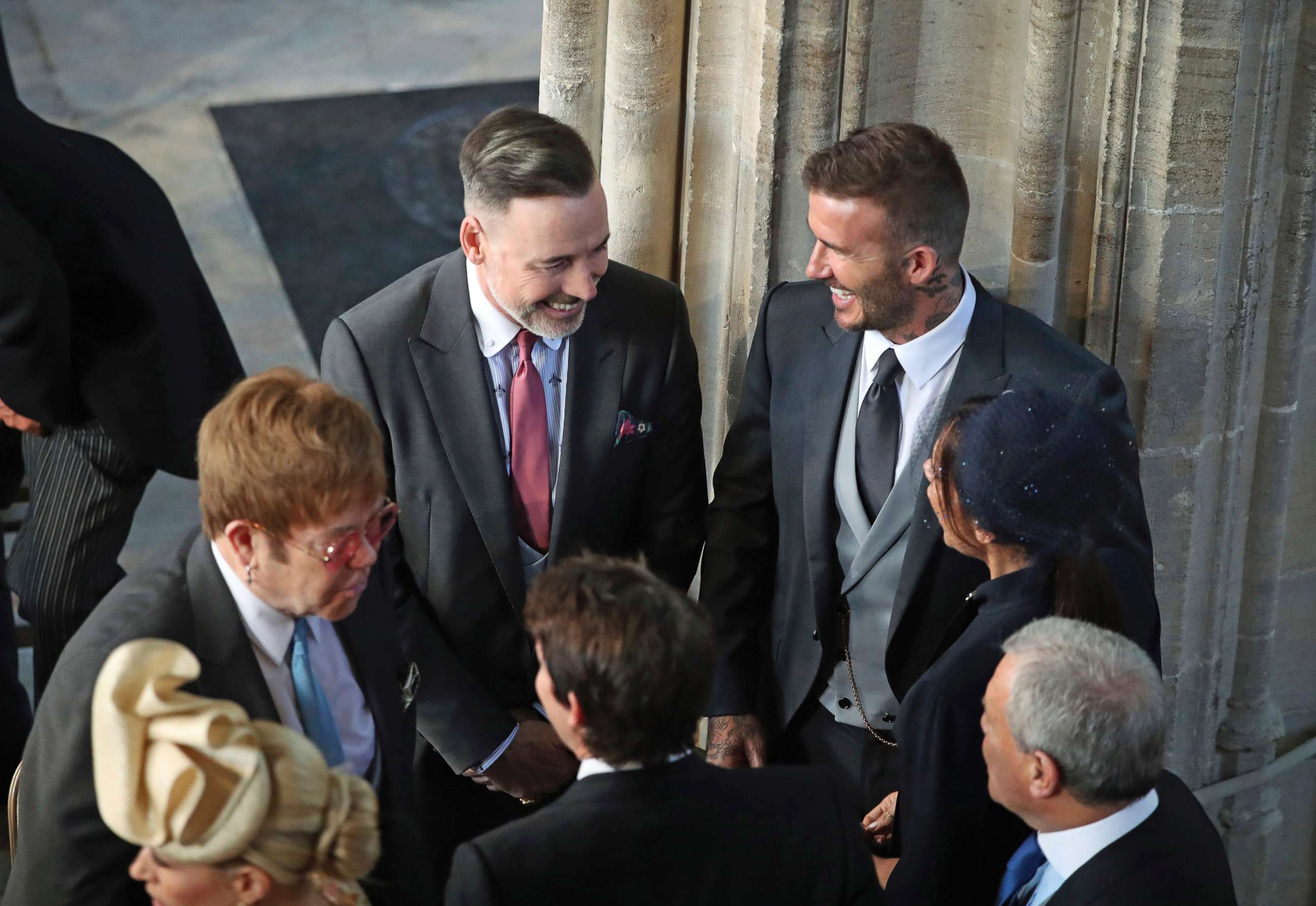 PHOTO: David and Victoria Beckham talk with Sir Elton John, left, and David Furnish as they arrive for the wedding ceremony of Prince Harry and Meghan Markle at St. George's Chapel in Windsor Castle in Windsor, May 19, 2018. 