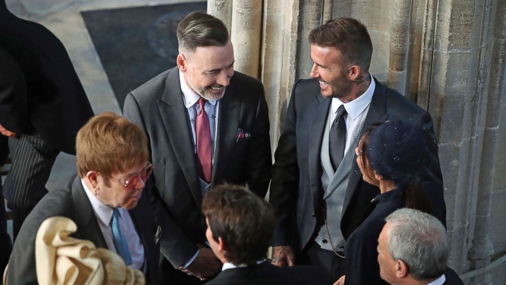 PHOTO: David and Victoria Beckham talk with Sir Elton John, left, and David Furnish as they arrive for the wedding ceremony of Prince Harry and Meghan Markle at St. George's Chapel in Windsor Castle in Windsor, May 19, 2018. 
