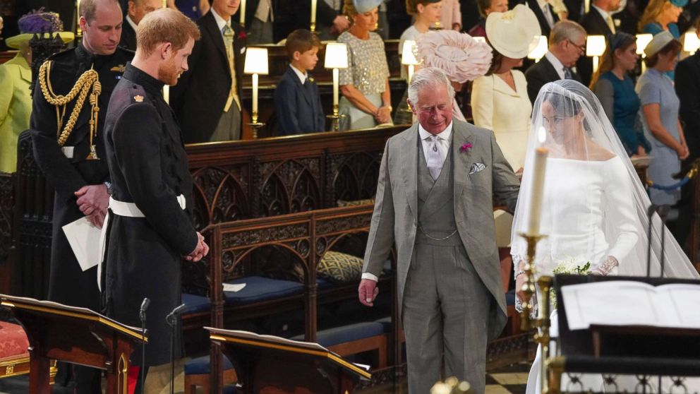 PHOTO: Prince Harry looks at his bride, Meghan Markle, as she arrives accompanied by Charles, the Prince of Wales, in St George's Chapel at Windsor Castle for their wedding, May 19, 2018. 