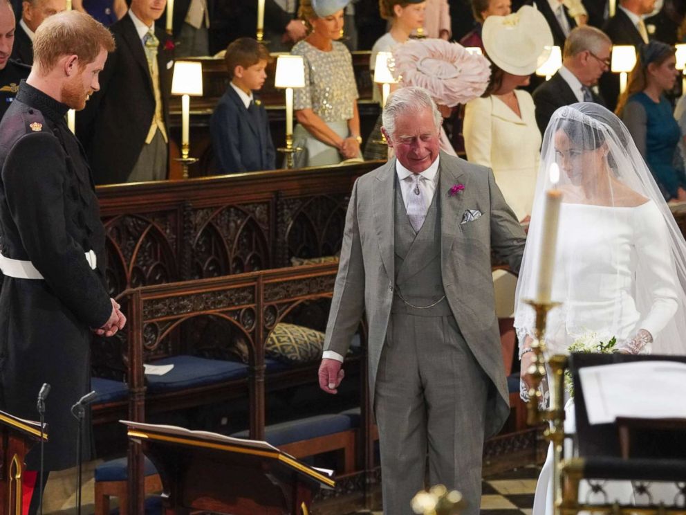 PHOTO: Prince Harry looks at his bride, Meghan Markle, as she arrives accompanied by Charles, the Prince of Wales, in St Georges Chapel at Windsor Castle for their wedding, May 19, 2018. 