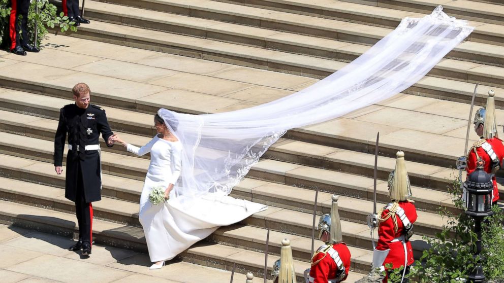 PHOTO: Prince Harry, Duke of Sussex and his wife Meghan, Duchess of Sussex walk down the west steps of St George's Chapel, Windsor Castle, in Windsor, on May 19, 2018 after their wedding ceremony. 