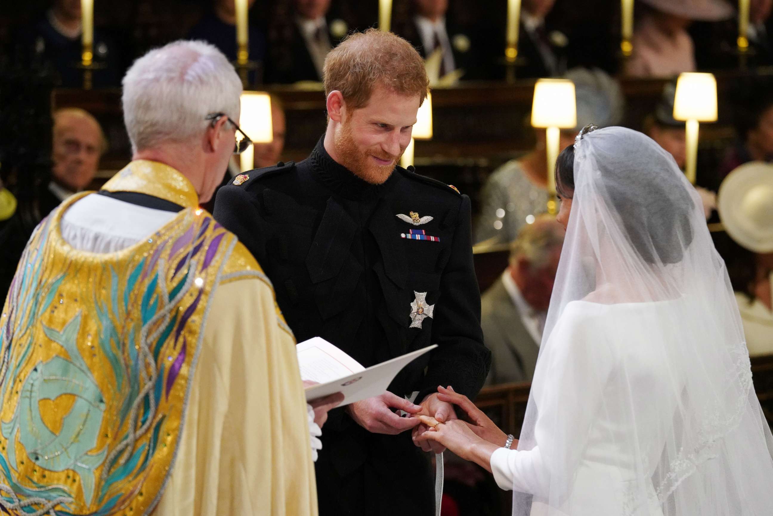 PHOTO: Prince Harry, Duke of Sussex, places the wedding ring on Meghan Markle during their wedding ceremony in St George's Chapel, Windsor Castle, in Windsor, on May 19, 2018. 