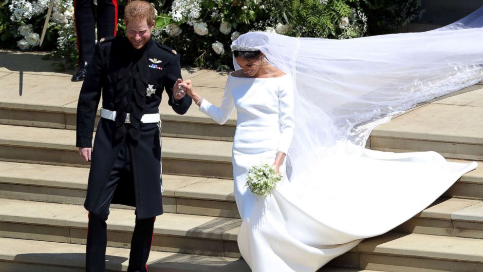 PHOTO: Prince Harry, Duke of Sussex and his wife Meghan, Duchess of Sussex emerge from the West Door of St George's Chapel, Windsor Castle, in Windsor, on May 19, 2018 after their wedding ceremony. 