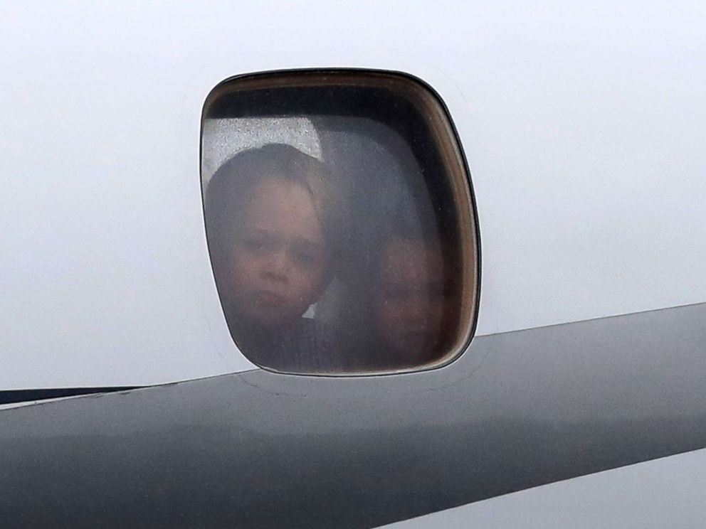 PHOTO: Prince George and Princess Charlotte peer out of a window as they arrive with Prince William and Catherine, Duchess of Cambridge on day 1 of their official visit to Poland, July 17, 2017, in Warsaw, Poland.