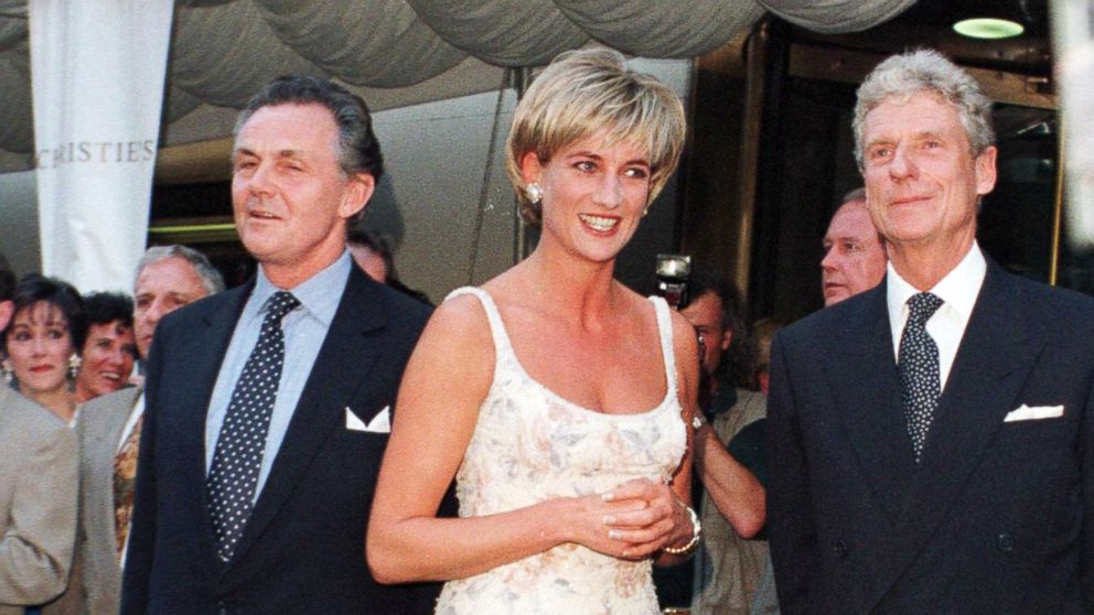 PHOTO: Princess Diana poses for photographs with Lord Hindlip, Chairman of Christie's International and Christopher Bafour Chairman of Christie's Europe at Christie's auction house in New York on June 23, 1997.