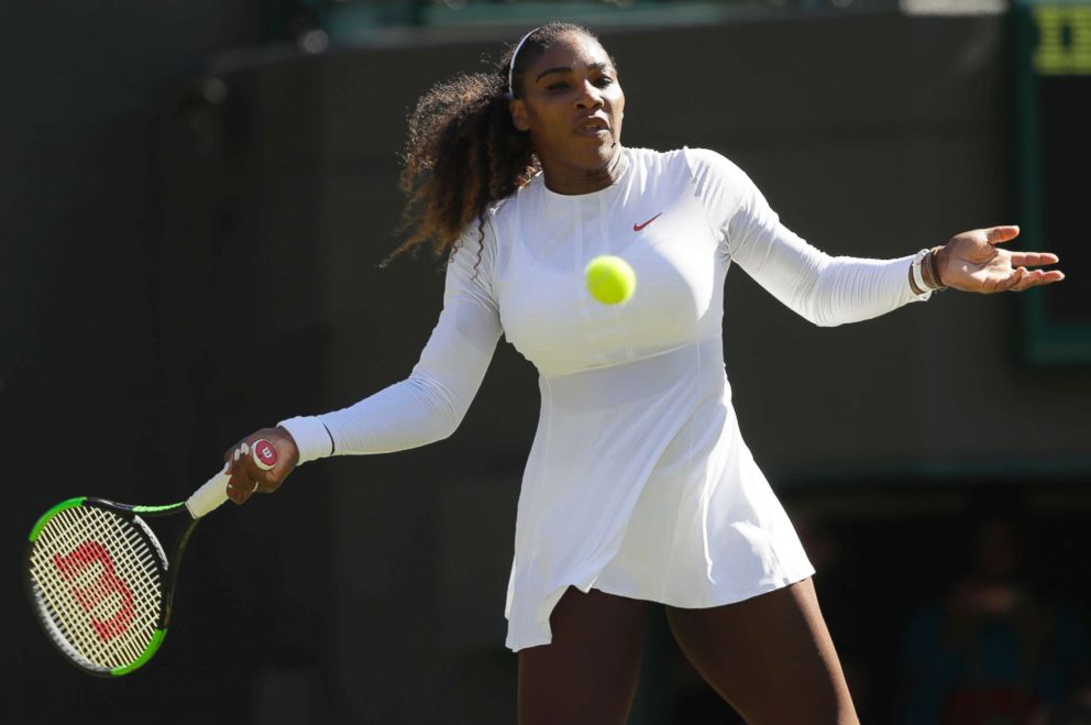 PHOTO: Serena Williams returns a ball to Arantxa Rus of the Netherlands during the Women's Singles first round match at the Wimbledon Tennis Championships in London, July 2, 2018. 