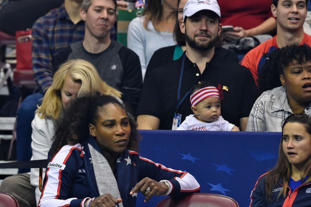 PHOTO: Serena Williams along with her husband Alexis Ohanian and their daughter Alexis Olympia, center, watch the action during the first round of the 2018 Fed Cup at US Cellular Center on Feb. 10, 2018 in Asheville, North Carolina. 