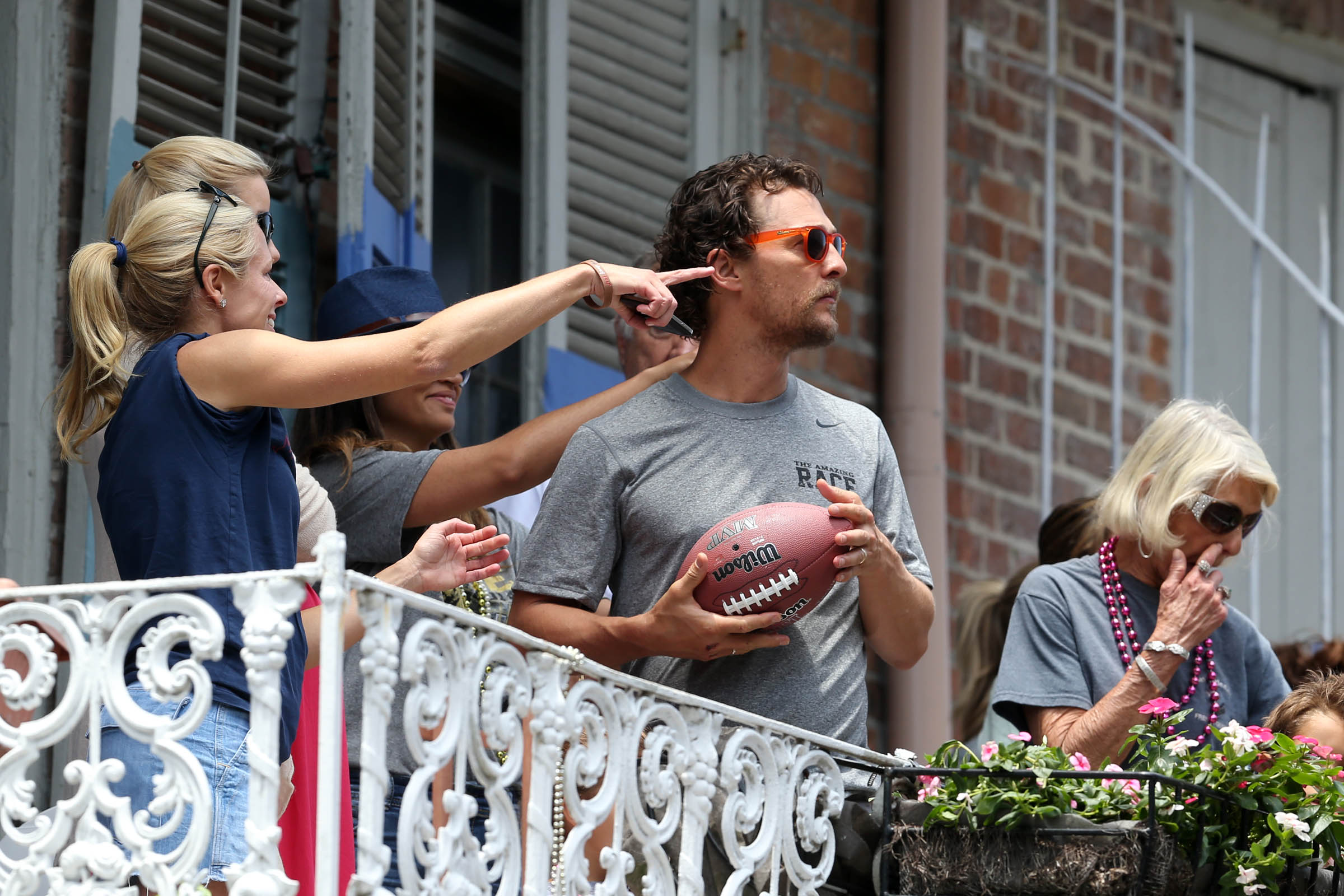 PHOTO: Brad Pitt and Matthew McConaughey chat with each other across balconies while McConaughey and his family participate in The Brees Dream Foundation charity fundraiser in New Orleans, Louisiana, May 17, 2014.