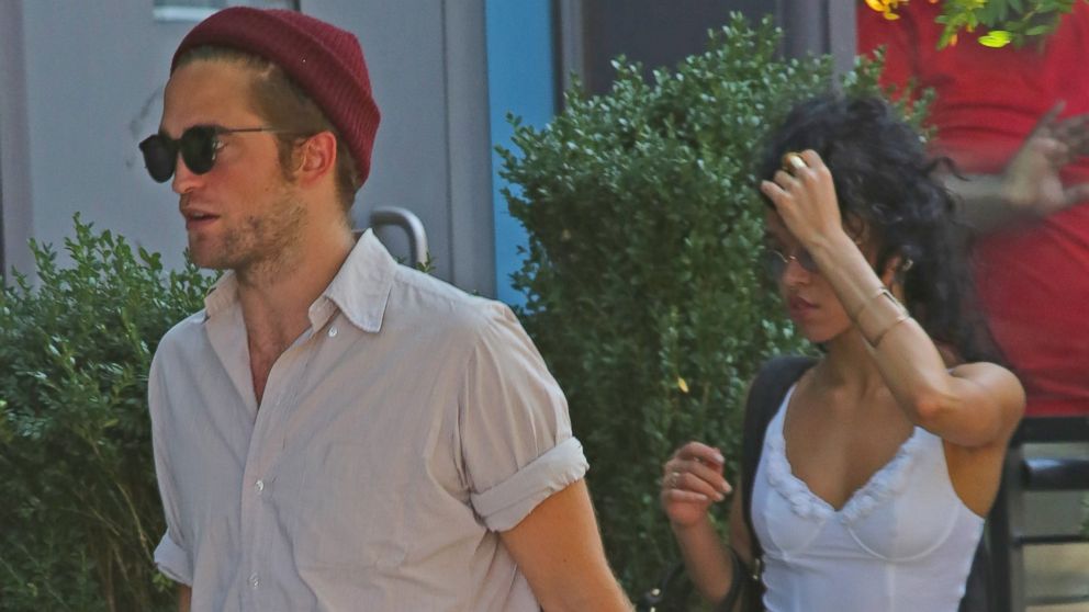 Robert Pattinson spotted walking around New York City with a mystery girl and friends on Aug. 27, 2014.