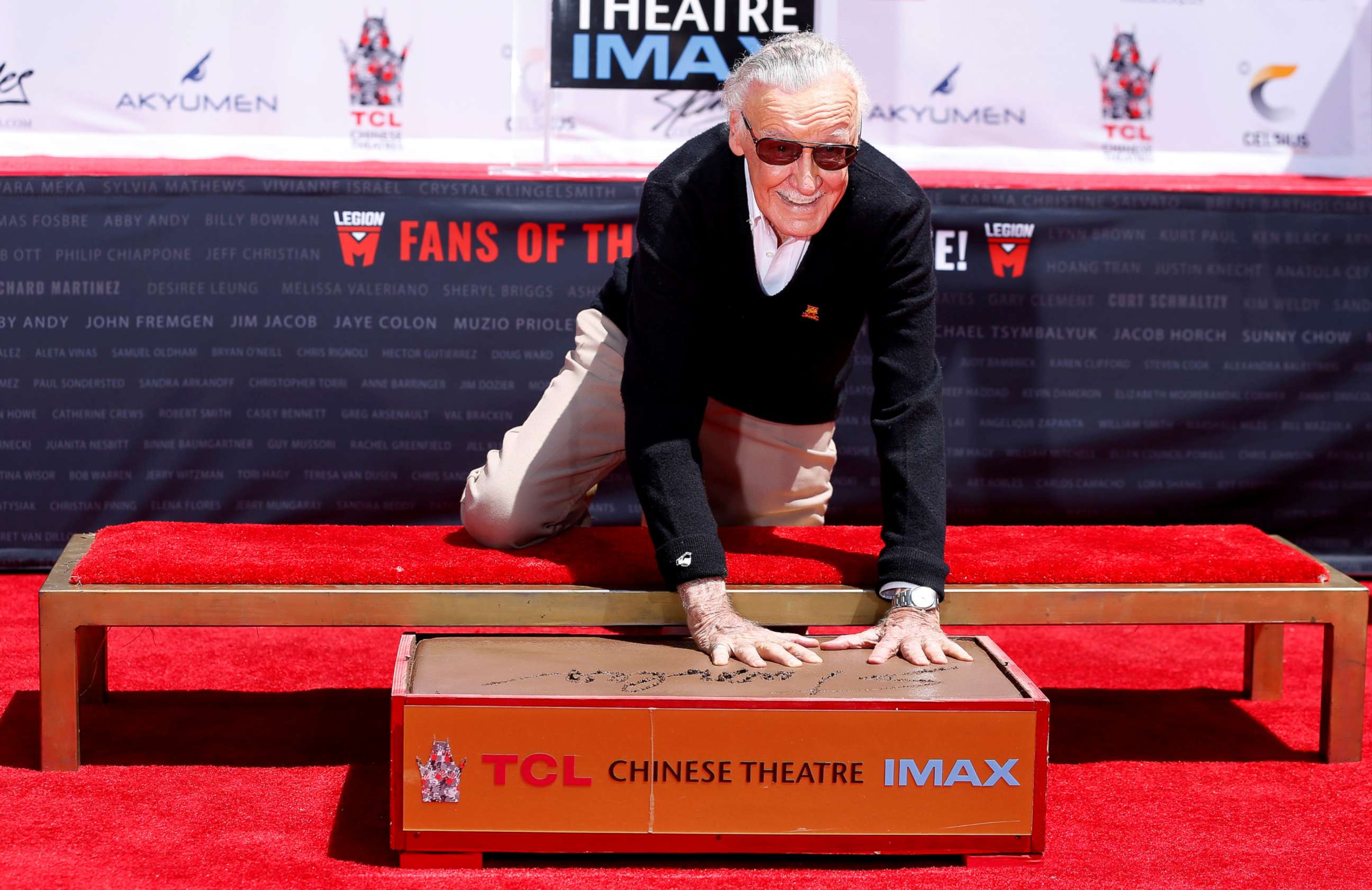 PHOTO: Marvel Comics co-creator Stan Lee places his handprints in cement during a ceremony at the TCL Chinese theatre in Los Angeles, July 18, 2017.   