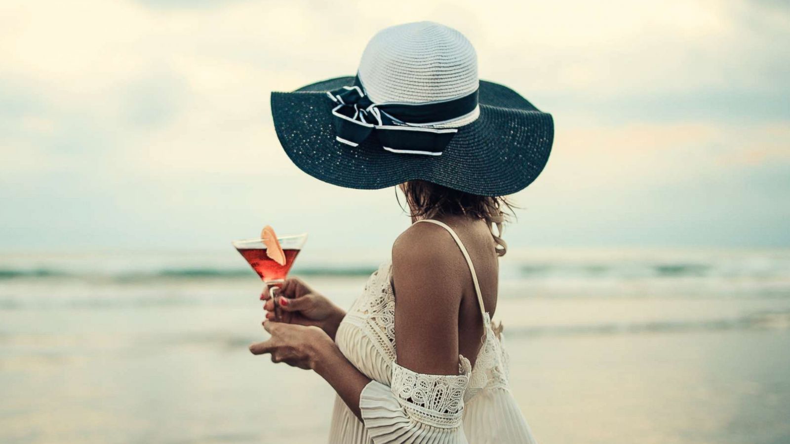 PHOTO: A woman wearing sun dress and hat enjoys the sunset in this undated stock photo.