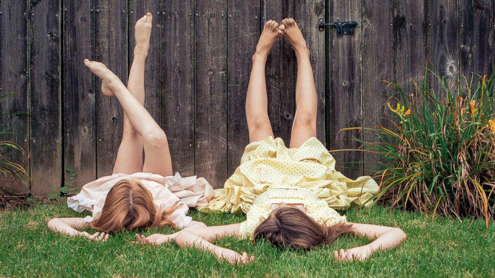 PHOTO: Two girls lay in the grass.