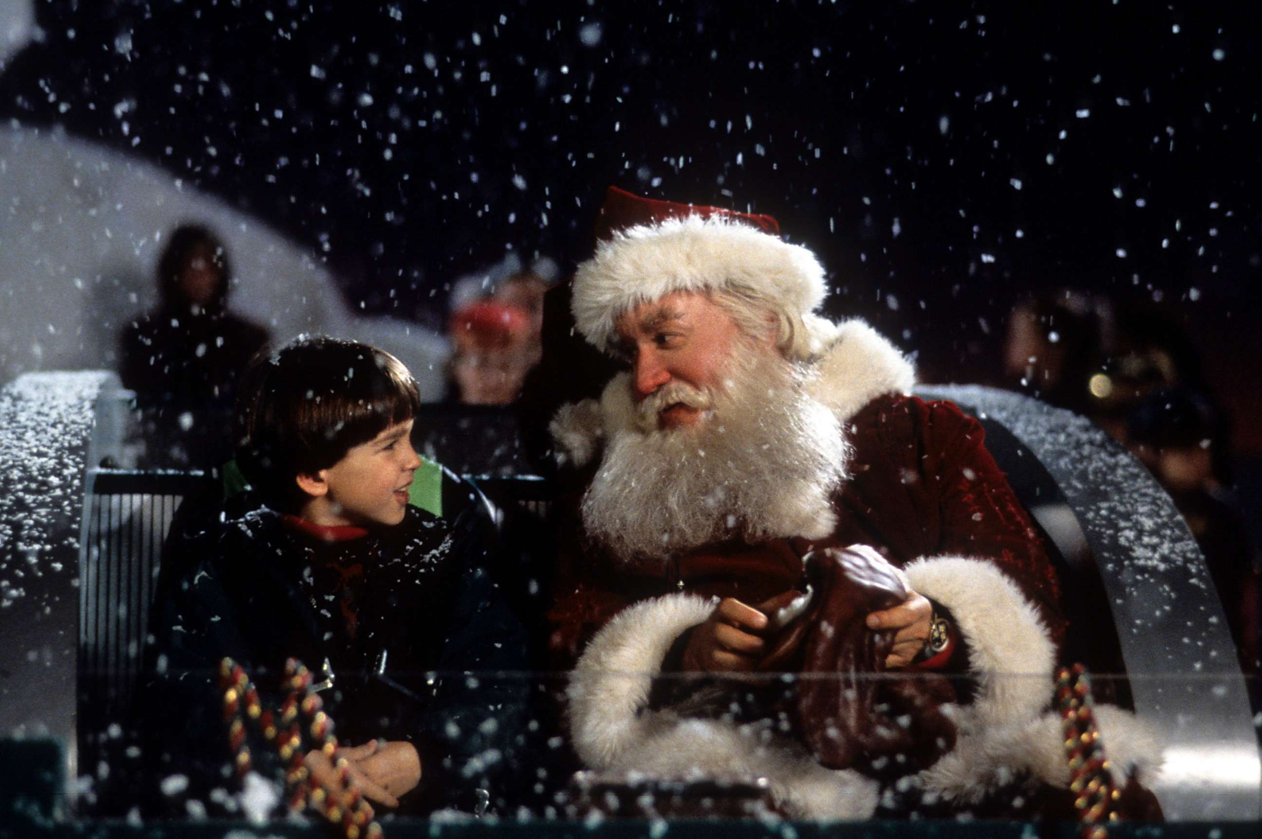 PHOTO: Tim Allen on a sled talking with Eric Lloyd in a scene from the film 'The Santa Clause', 1994. 