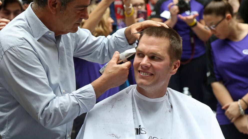 PHOTO: New England Patriots quarterback Tom Brady gets his head shaved by Pini Swissa at the "Saving By Shaving" event in support of the Dana-Farber Cancer Institute at Granite Telecommunications in Quincy, Mass., March 8, 2018.