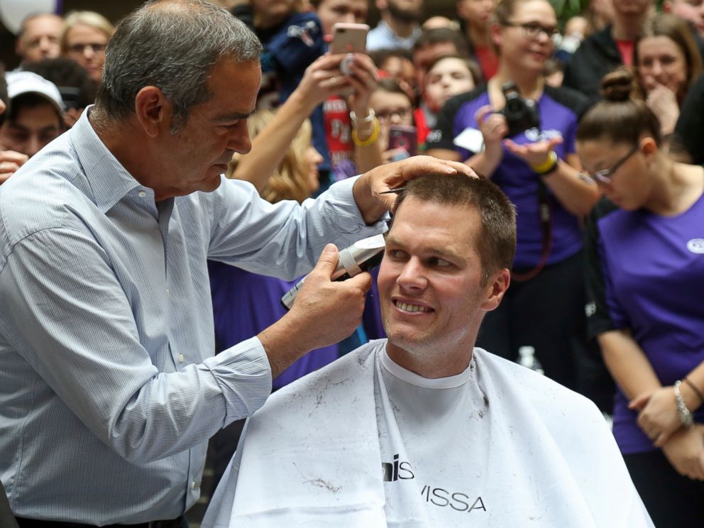 PHOTO: New England Patriots quarterback Tom Brady gets his head shaved by Pini Swissa at the Saving By Shaving event in support of the Dana-Farber Cancer Institute at Granite Telecommunications in Quincy, Mass., March 8, 2018.