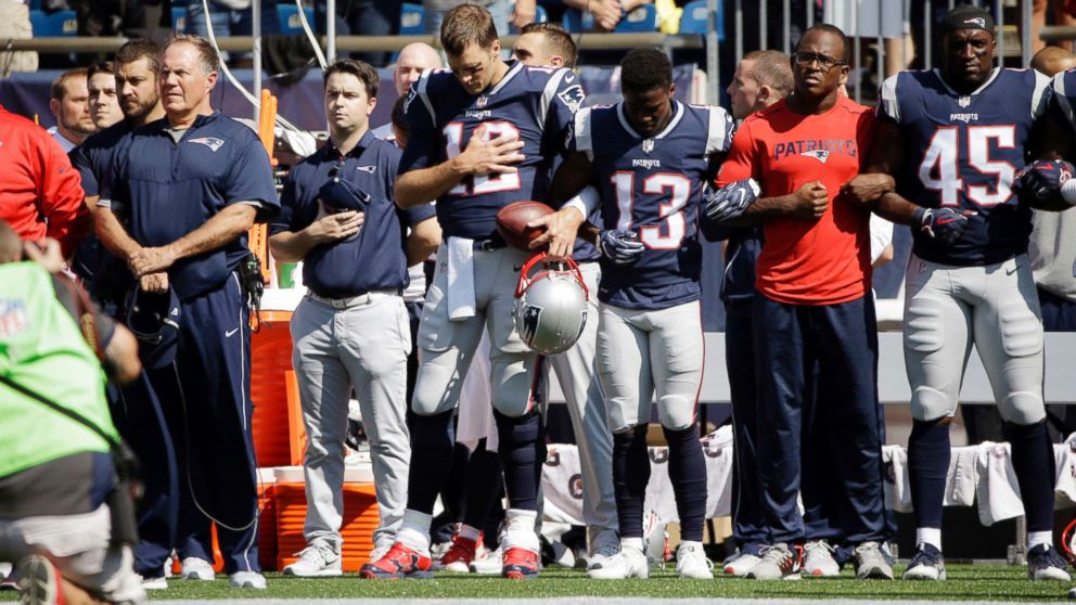 New England Patriots head coach Bill Belichick, left, and Tom Brady, Phillip Dorsett, Matthew Slater, second from right, and David Harris, stand during the national anthem before an NFL football game against the Houston Texans, Sept. 24, 2017, in Foxborough, Mass.