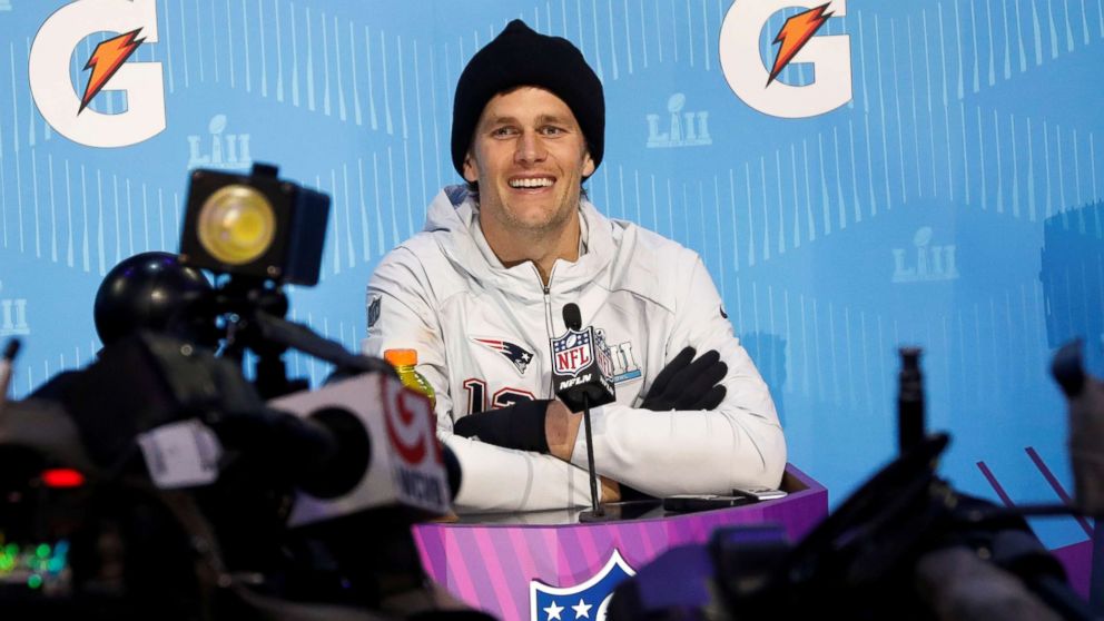 PHOTO: New England Patriots quarterback Tom Brady smiles as he speaks to reporters during Super Bowl Opening Night at the Xcel Energy Center in St. Paul, Minn., Jan. 29, 2018. 