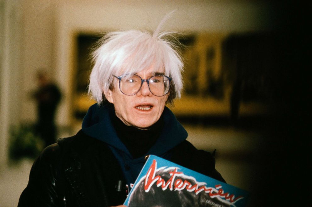 Andy Warhol holds an issue of his magazine "Interview," circa 1975 in Italy. 