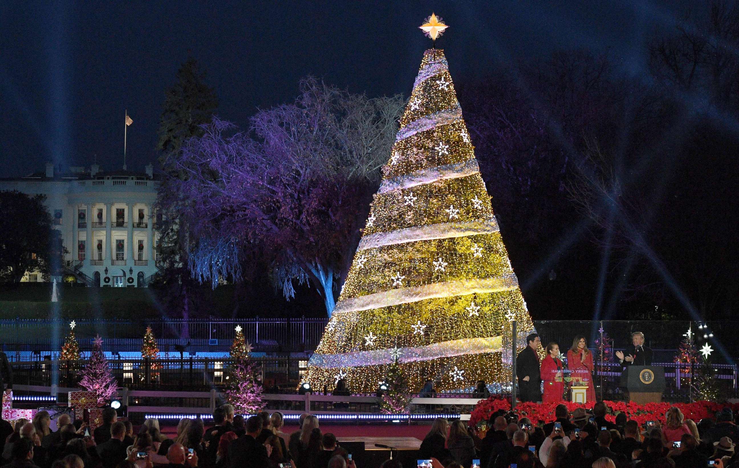 PHOTO: US President Donald Trump claps next to First Lady Melania Trump during the 95th annual National Christmas Tree Lighting ceremony at the Ellipse in President's Park near the White House in Washington on November 30, 2017. 