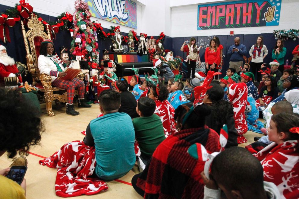 PHOTO: Children gather around to listen as Whoopi Goldberg reads a holiday classic story.