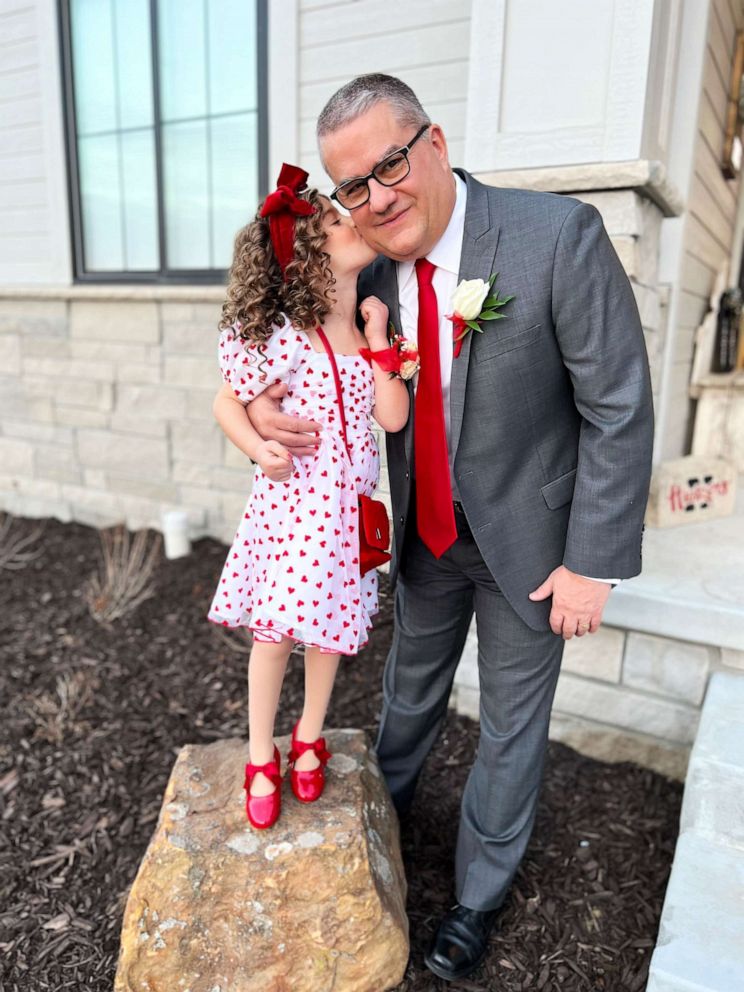 PHOTO: Austyn gives her grandfather, Steve Guenther, a kiss on the cheek. The 5-year-old and her grandpa attended a local Valentine's Day-themed daddy-daughter dance together last week.