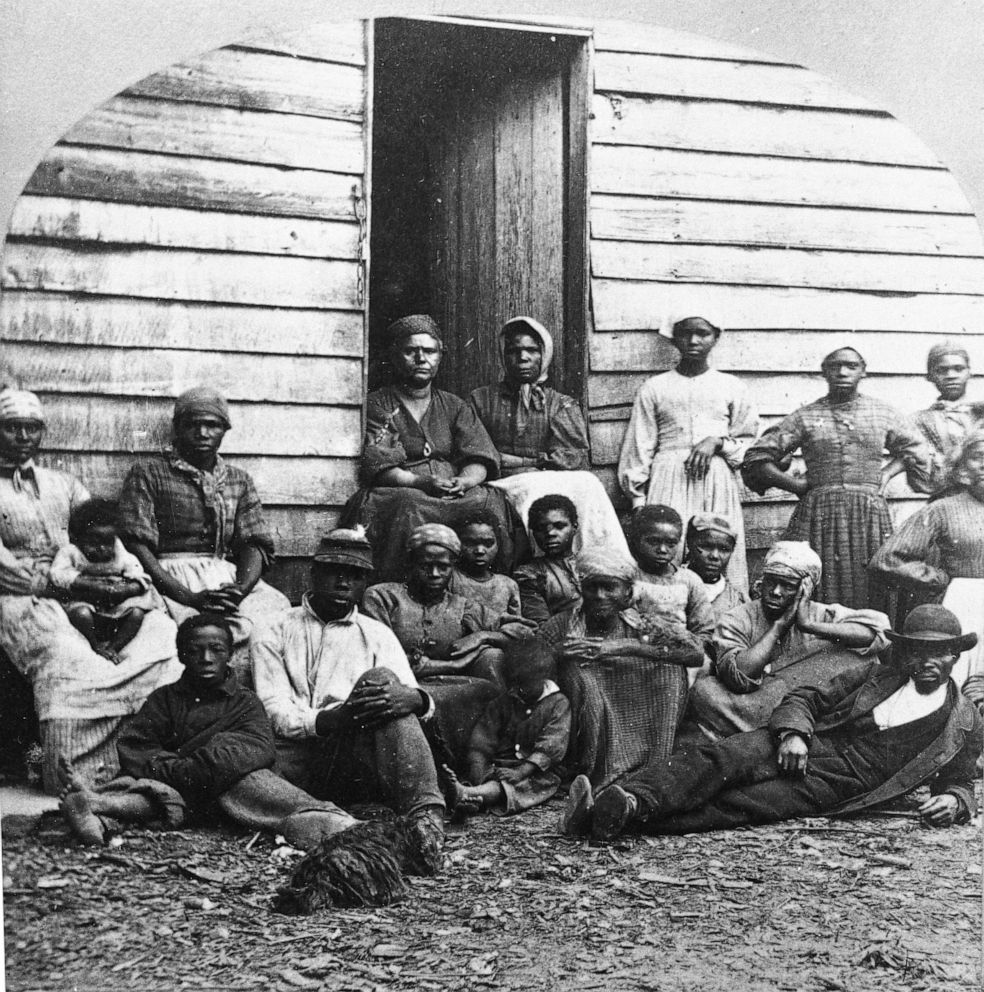 PHOTO: A group of fugitive slaves who were emancipated upon reaching the North, sitting outside a house, possibly in Freedman's Village in Arlington, Va., in the mid 1860s.