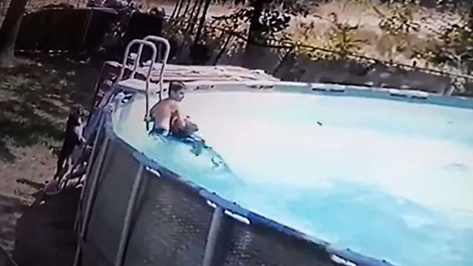 PHOTO: Gavin Keeney dives into the water to rescue his mother Lori as she suffers a seisure while in their backyard pool in Enos, Okla., Aug. 5, 2022.