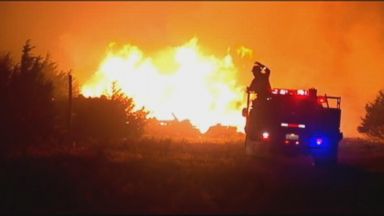 VIDEO: Gusting winds sparked flames that have put hundreds of homes in jeopardy in city of Guthrie.