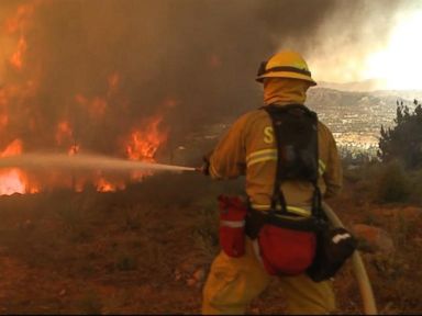 VIDEO: Firefighters battle the blazes overnight as 23,000 evacuation notices have been issued.