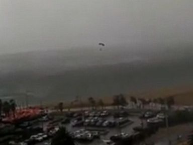 VIDEO: The skydivers landed in waters off an Australian beach during a freak hail storm.