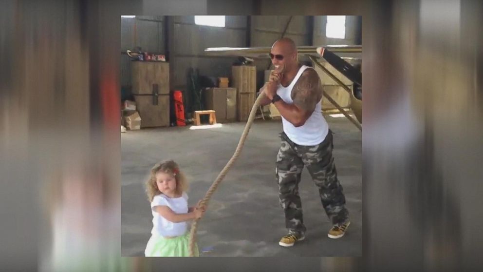 Dwayne 'The Rock' Johnson helps a 2-year-old pull a plane: see the video