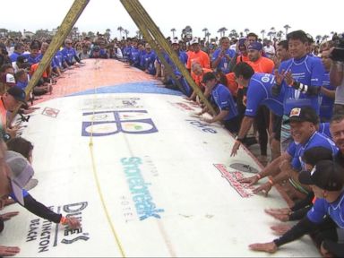 VIDEO: World Record Attempt for Most People Surfing On a Single Board