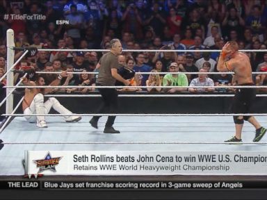 VIDEO: The former "Daily Show" host played a villain during a bout between US Champion John Cena and WWE World Heavyweight Champion Seth Rollins.