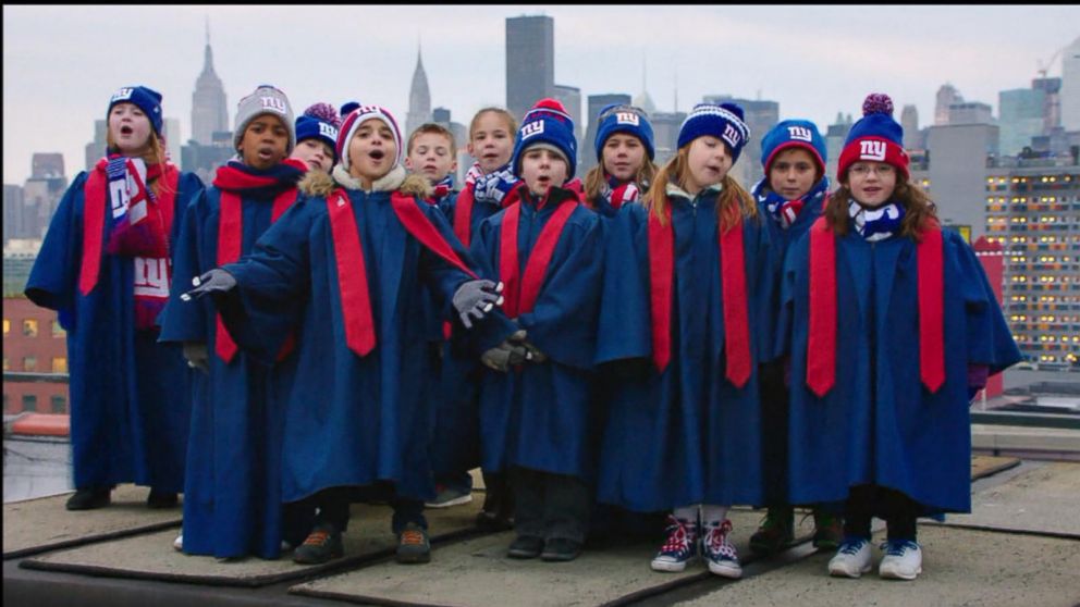 VIDEO: Choruses of kids born 9 months after the Super Bowl sing Seals Kissed from a Rose.