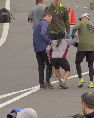 VIDEO: Two runners stopped to help the woman in the Philadelphia Love Run Half Marathon while a third runner carried her to the finish.