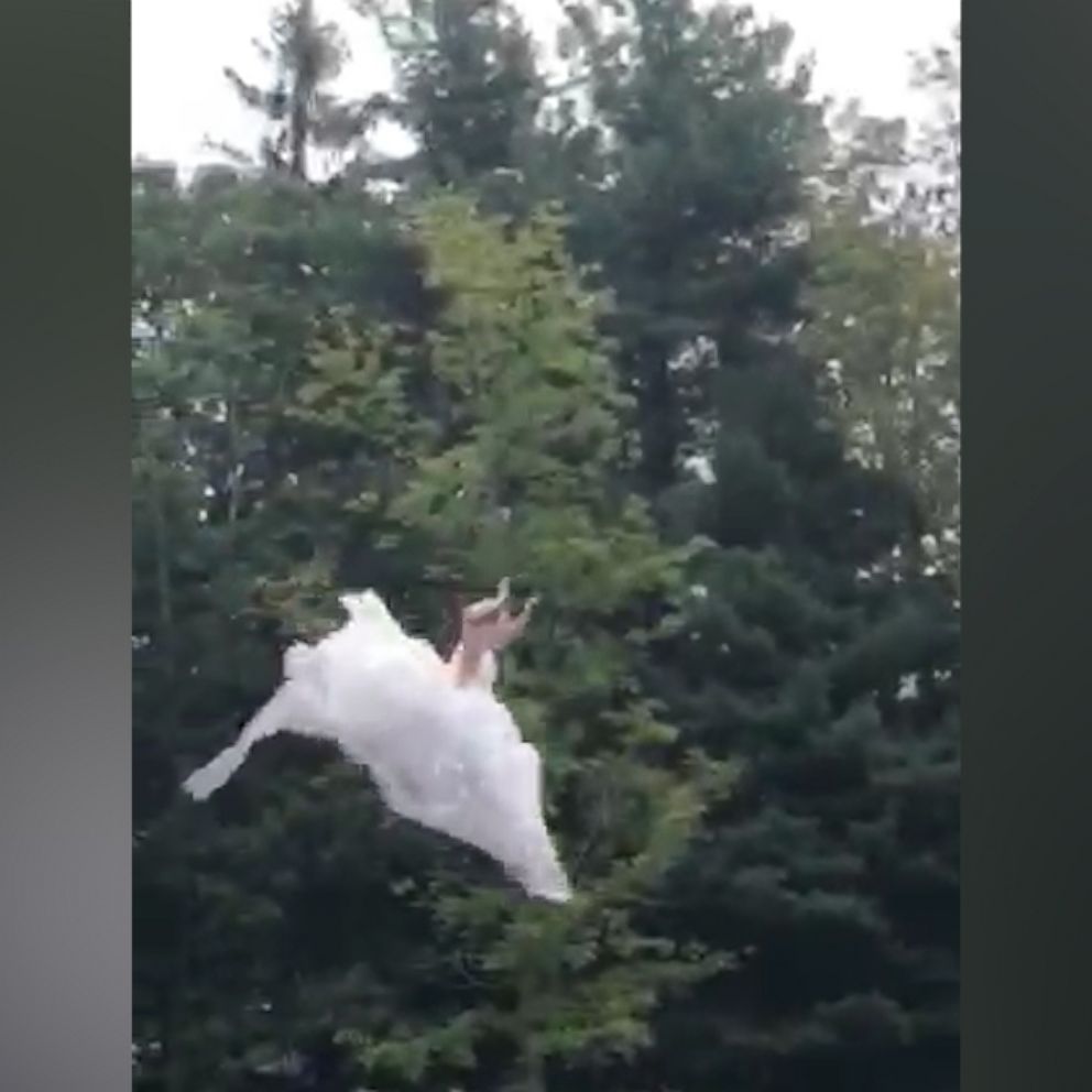 VIDEO: This out-of-the box bride 'blobs' into a lake in her wedding dress
