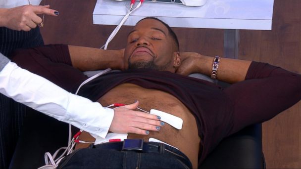 Michael Strahan gets hooked up to a machine that simulates labor