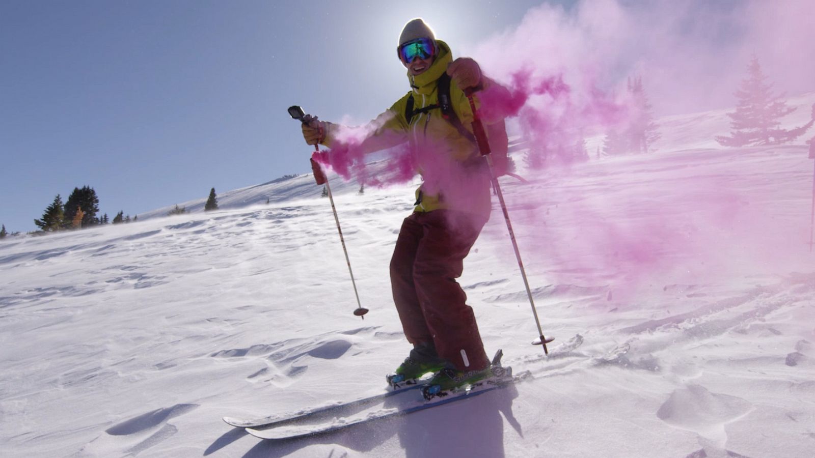 PHOTO: Greg Day skis down a mountain in Breckenridge, Colorado with clouds of pink smoke after finding he and his wife Amanda will have a baby girl.