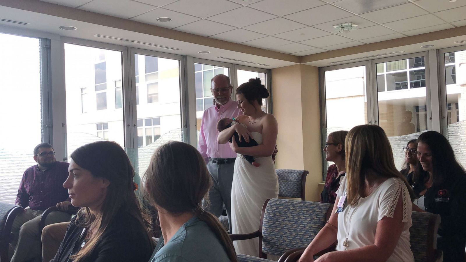 PHOTO: Amanda Acevedo walks down the aisle holding her baby, Oliver.