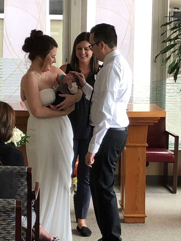 PHOTO: Amanda and Edwin Acevedo get married with baby Oliver in hand. 