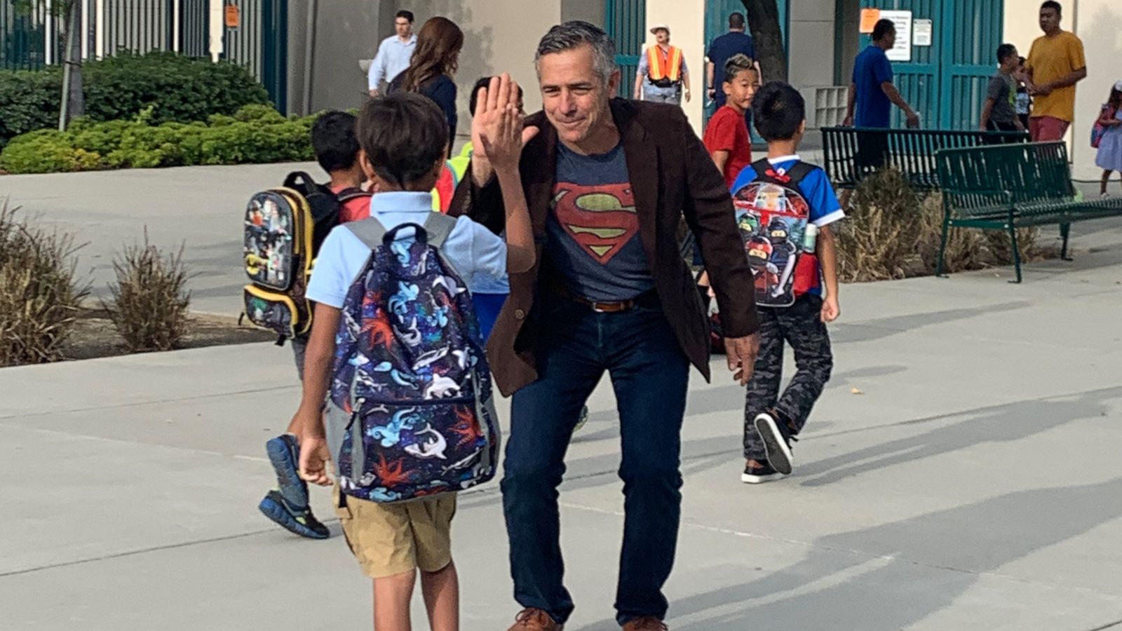 VIDEO: Principal who accepted 'air hugs' during chemo returns to greet kids cancer-free