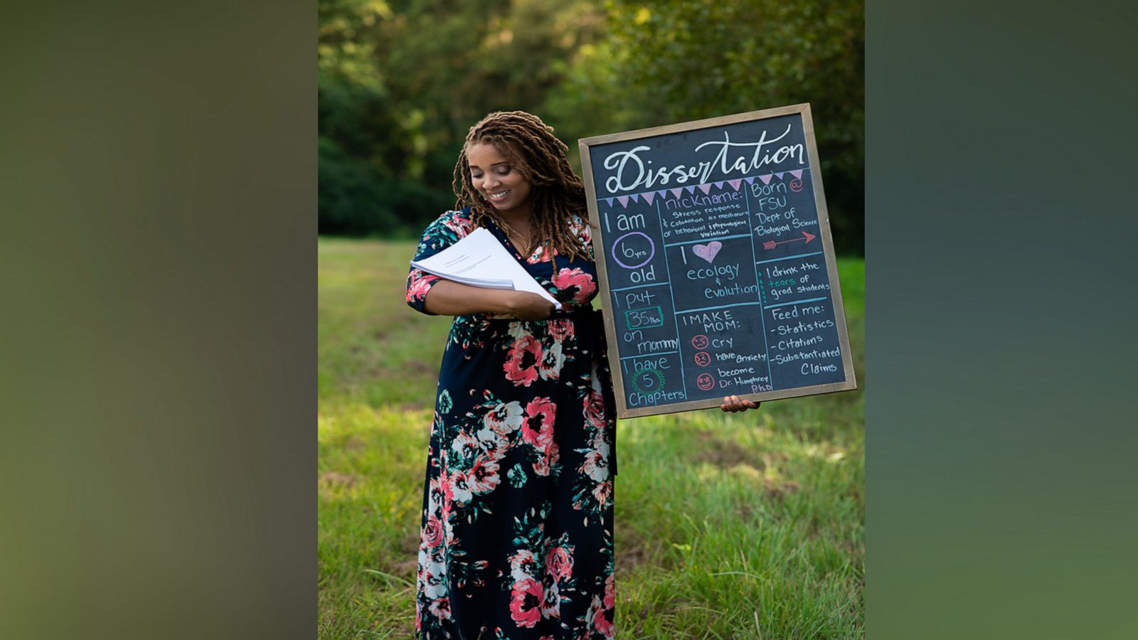 VIDEO: Woman poses with dissertation in newborn photoshoot spoof