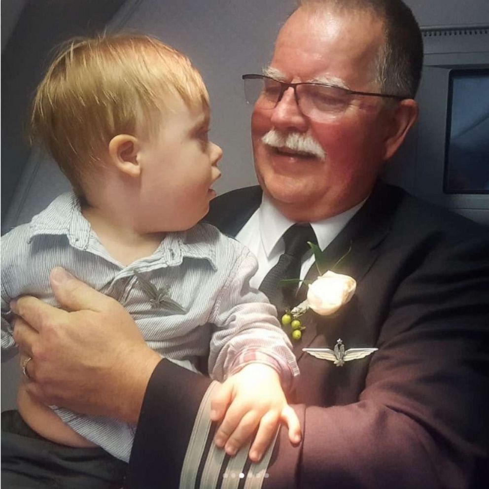 PHOTO: American Airlines pilot Joe Weis gave his captain's wings to two-year-old Ki Alsedek at the completion of his final flight. 