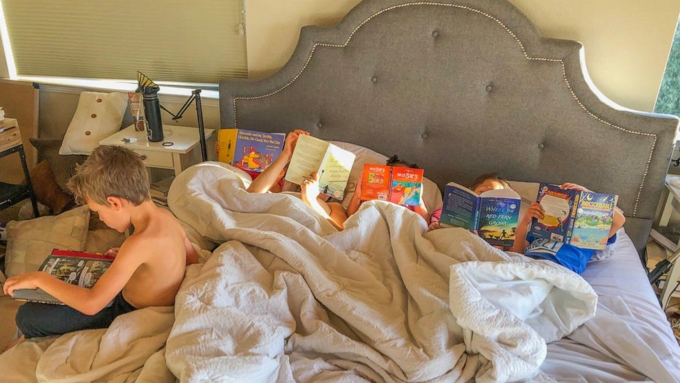 PHOTO: Molly DeFrank's children lying in bed and reading. 