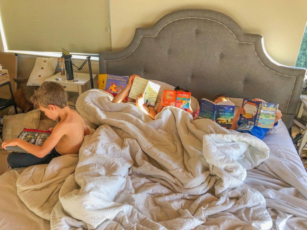 PHOTO: Molly DeFrank's children lying in bed and reading. 