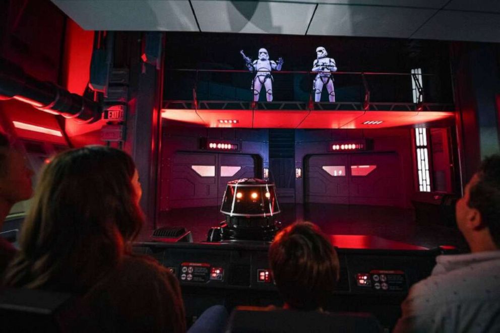 PHOTO: Guests flee First Order Stormtroopers onboard a Star Destroyer as part of Star Wars: Rise of the Resistance. 
