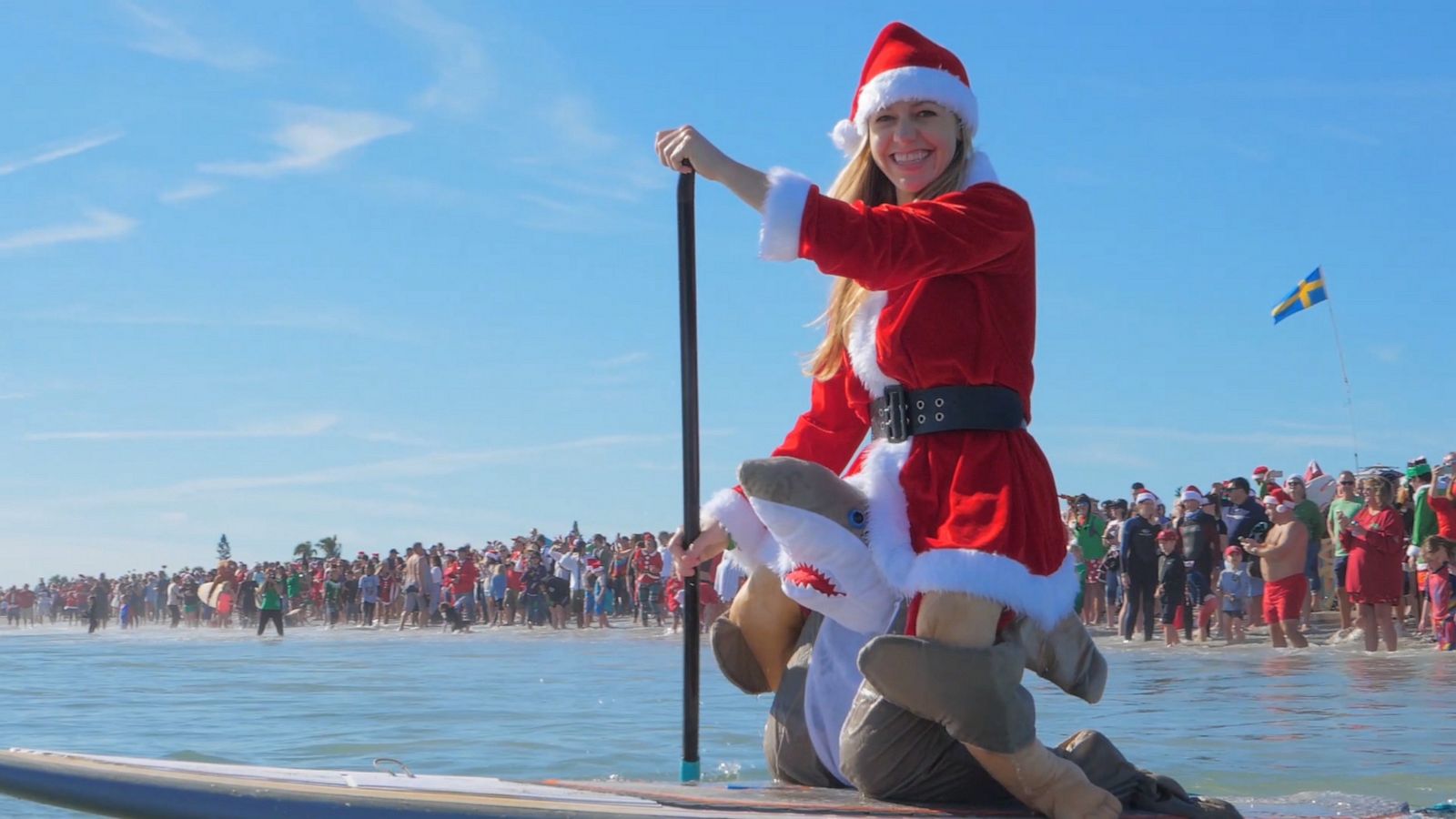 VIDEO: Surfing Santas ride a wave of holiday cheer from the ocean to a Florida hospital